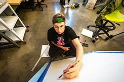 Student works on canvas in Art and Design building lab